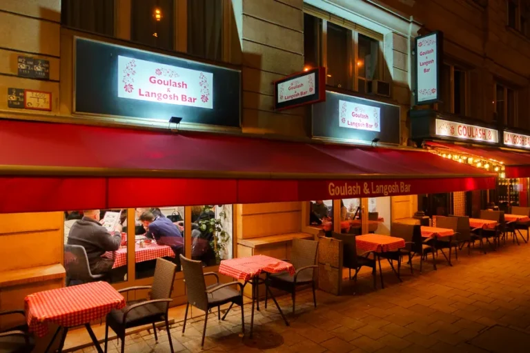 Mama Paprika's terrace under the red awning in the evening