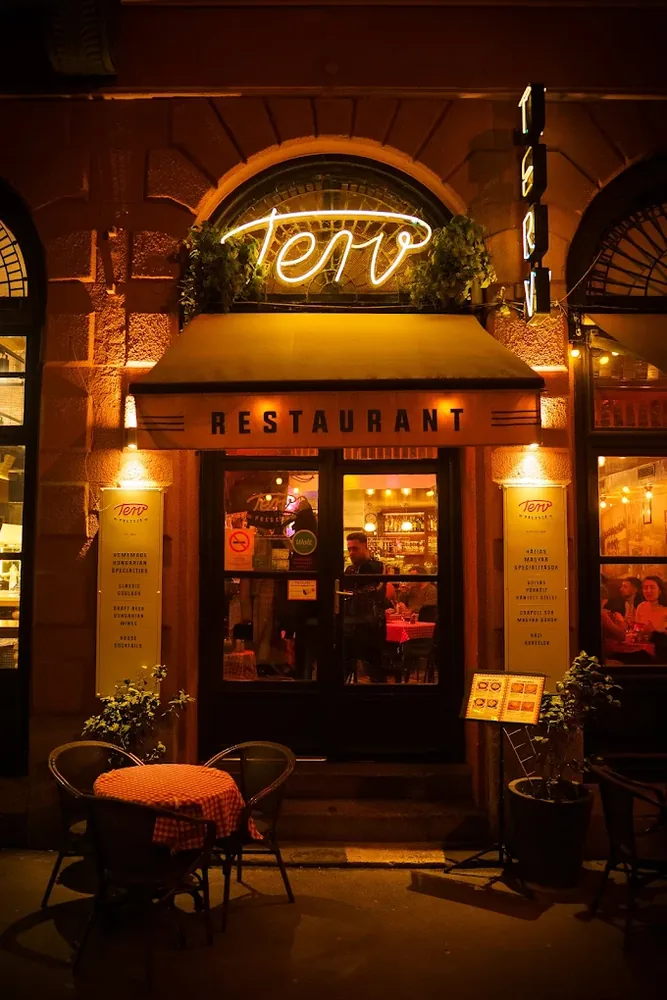 The doorway of Terv Presszó under its neon sign
