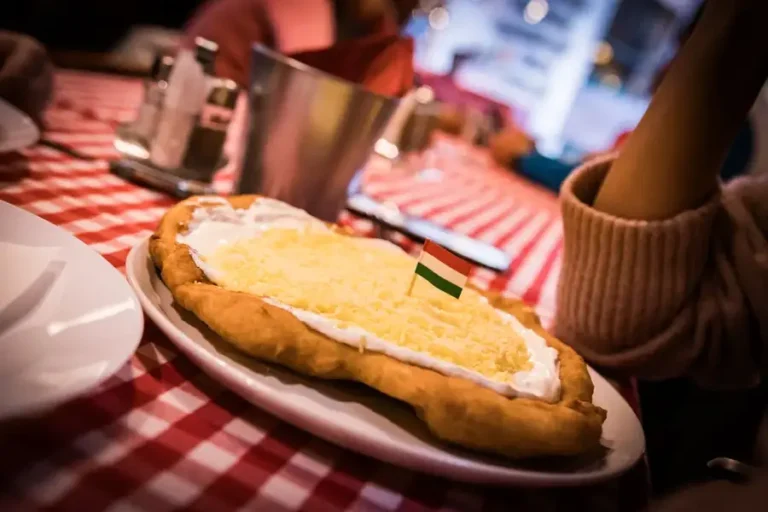Langosh with sour cream and grated cheese